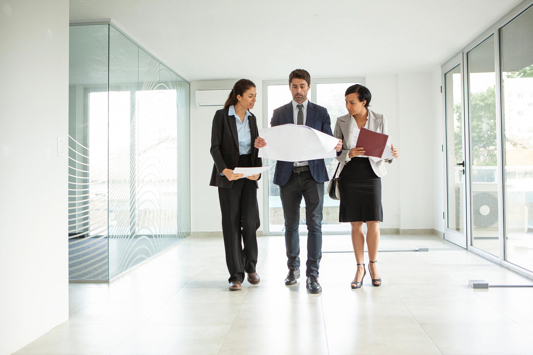 Real estate professionals reviewing plans and market details