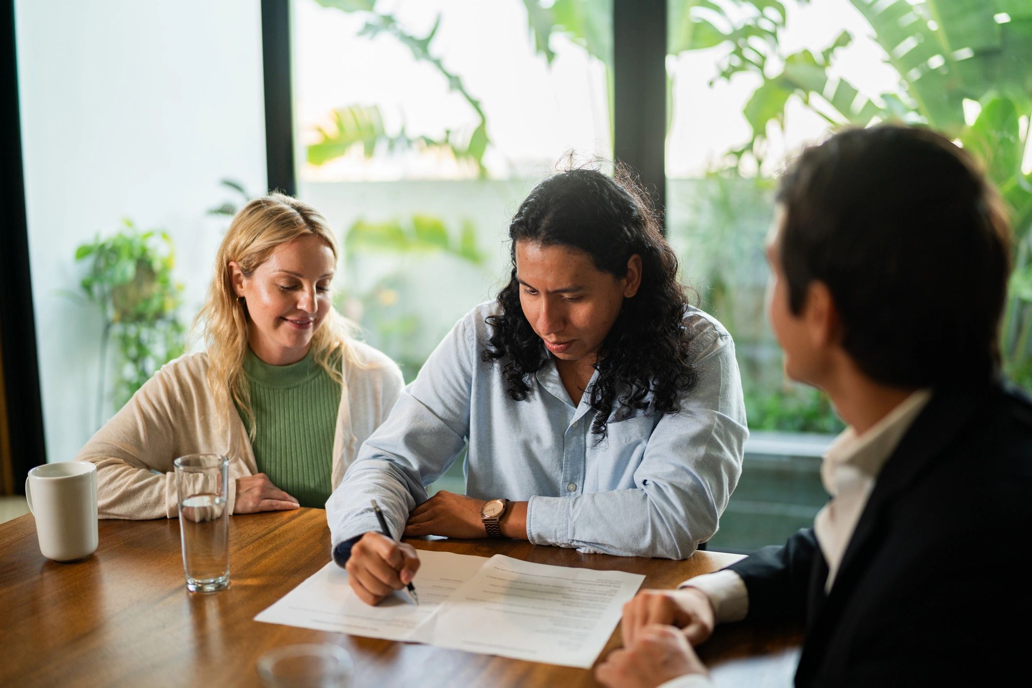 Happy home buyers meeting with a real estate agent